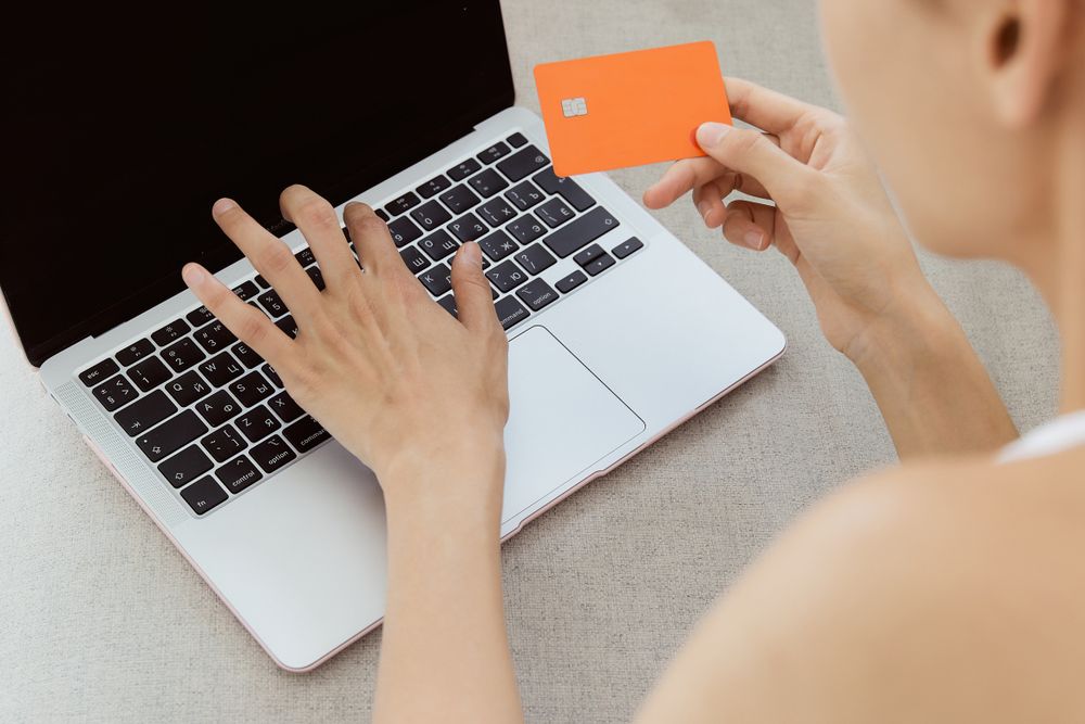 Person managing online banking on a laptop