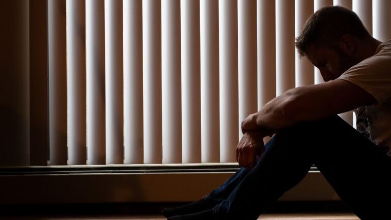 Person with head in hands worried about their credit record