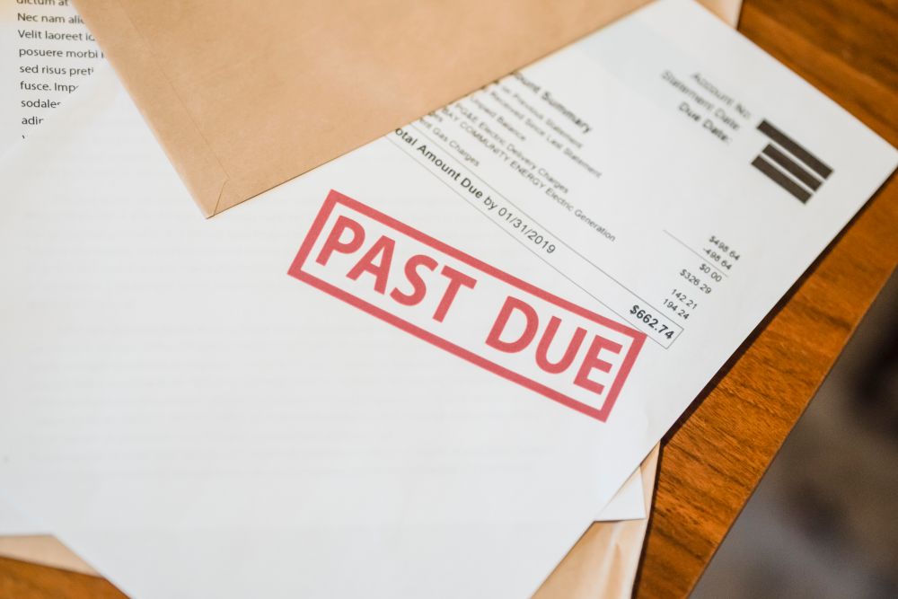 Person stressed over overdue bills, the worry behind the word blacklisted