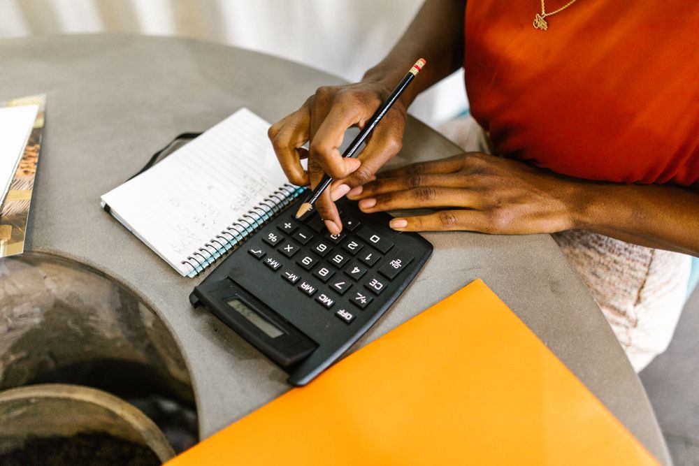 Notebook ledger and phone for tracking a monthly budget