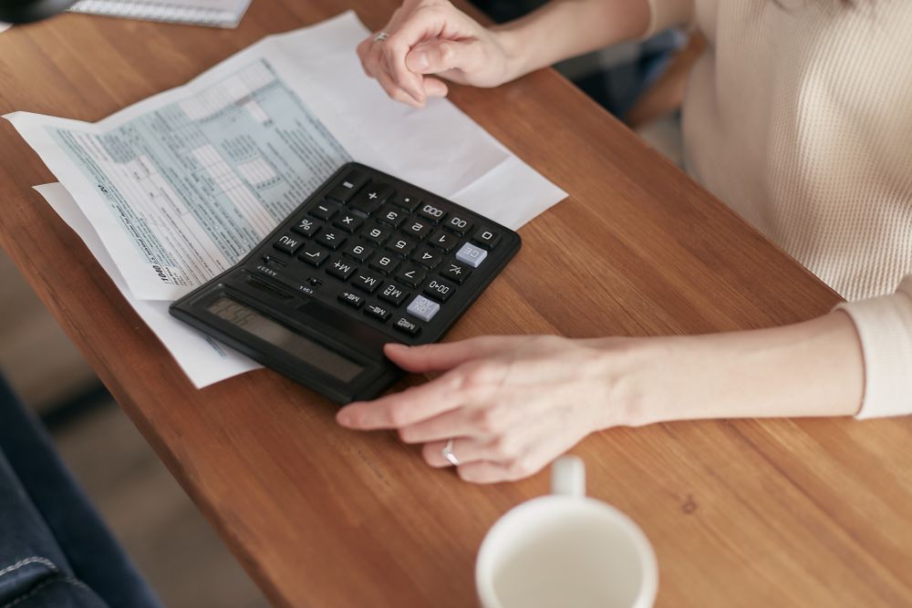Couple going through household finances at a table, reviewing accounts together to build credit