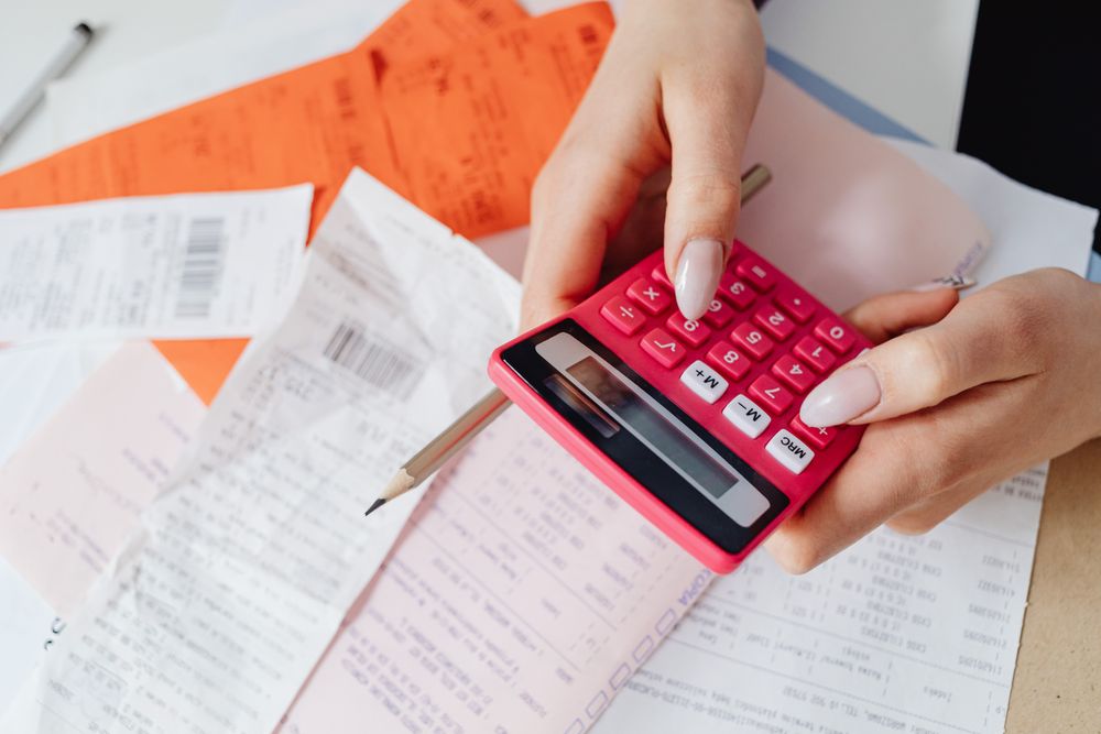 Person going through bills and receipts at a table