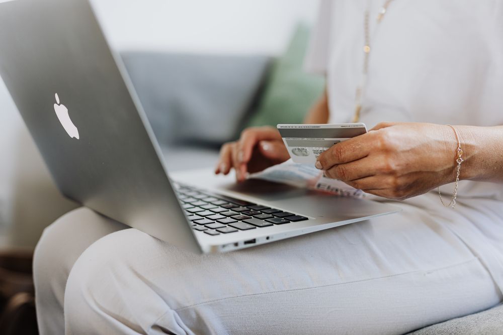 Person managing online banking on a laptop