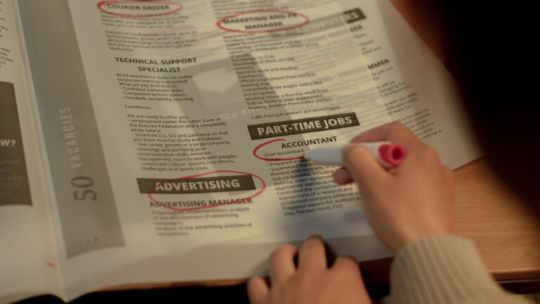Person searching for work with a CV and job notices