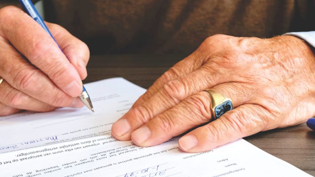 Person signing a document to finish a debt repayment plan