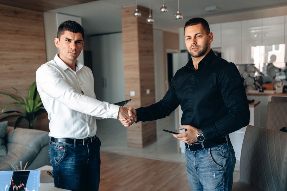 Handshake over an agreement, the finish line of a debt review and the clearance certificate that proves it