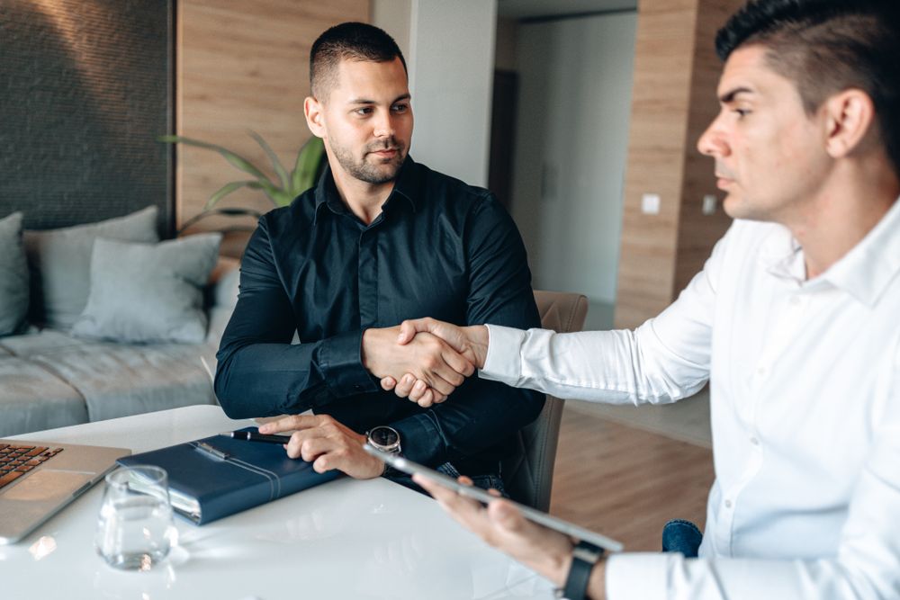 Handshake over an agreement, the moment before you sign a credit agreement