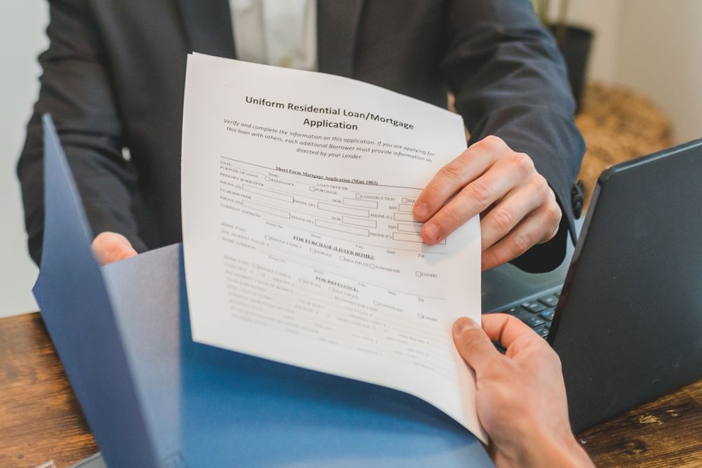Loan paperwork being reviewed with an adviser