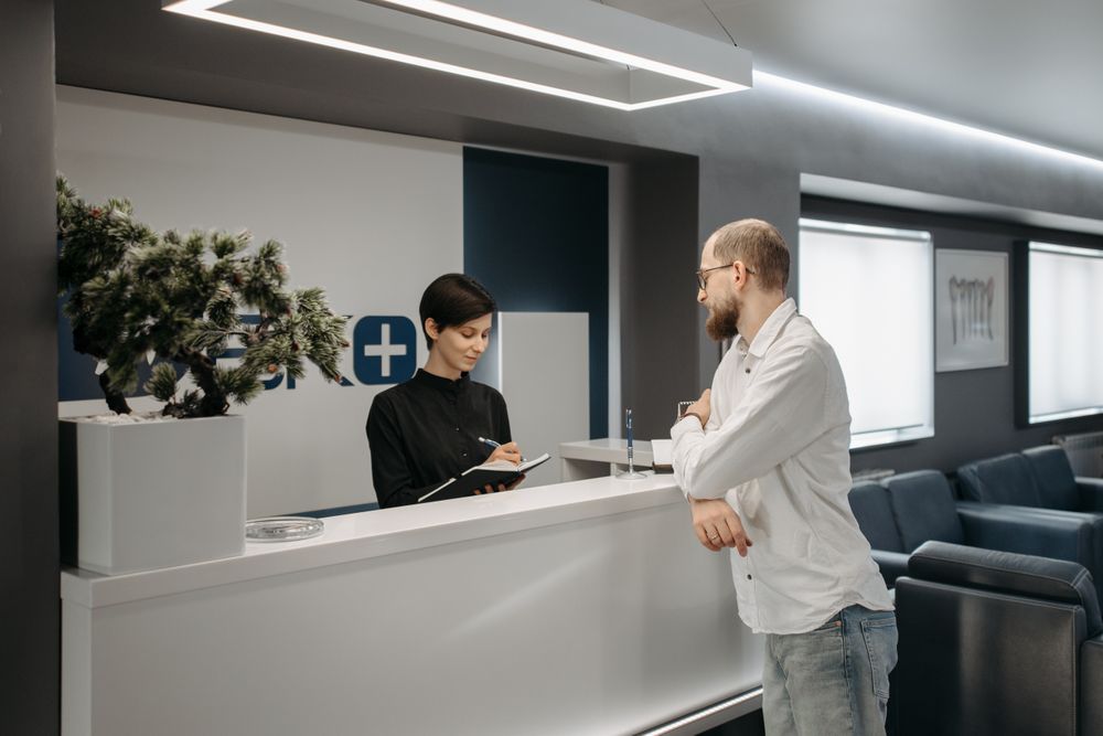 Customer at a bank counter, where banks and other lenders collect the information a credit bureau holds