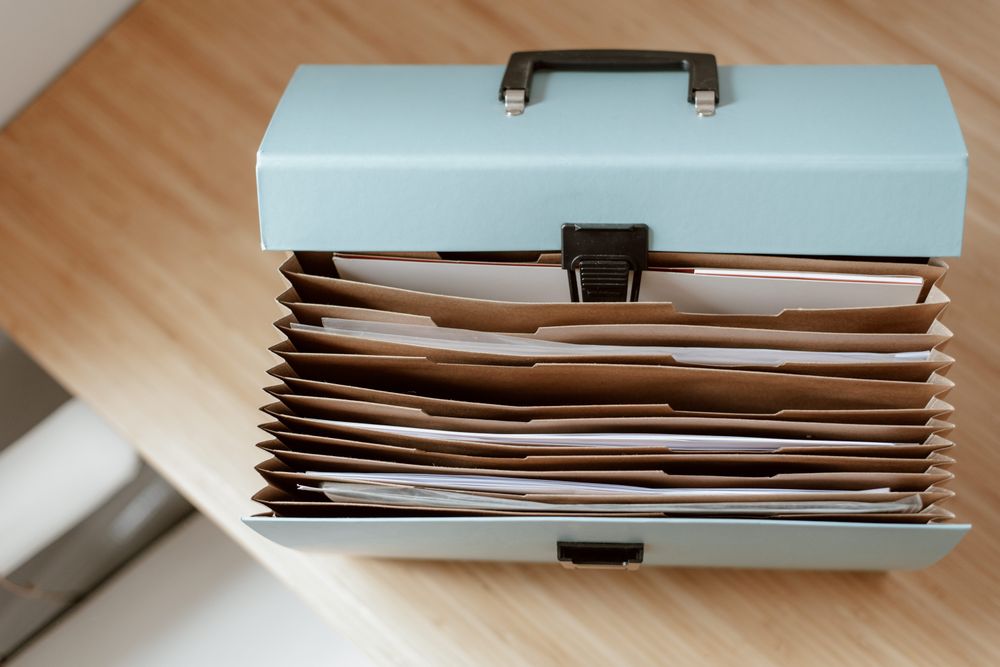 Folders and binders of financial paperwork, the proof to gather for a credit report dispute