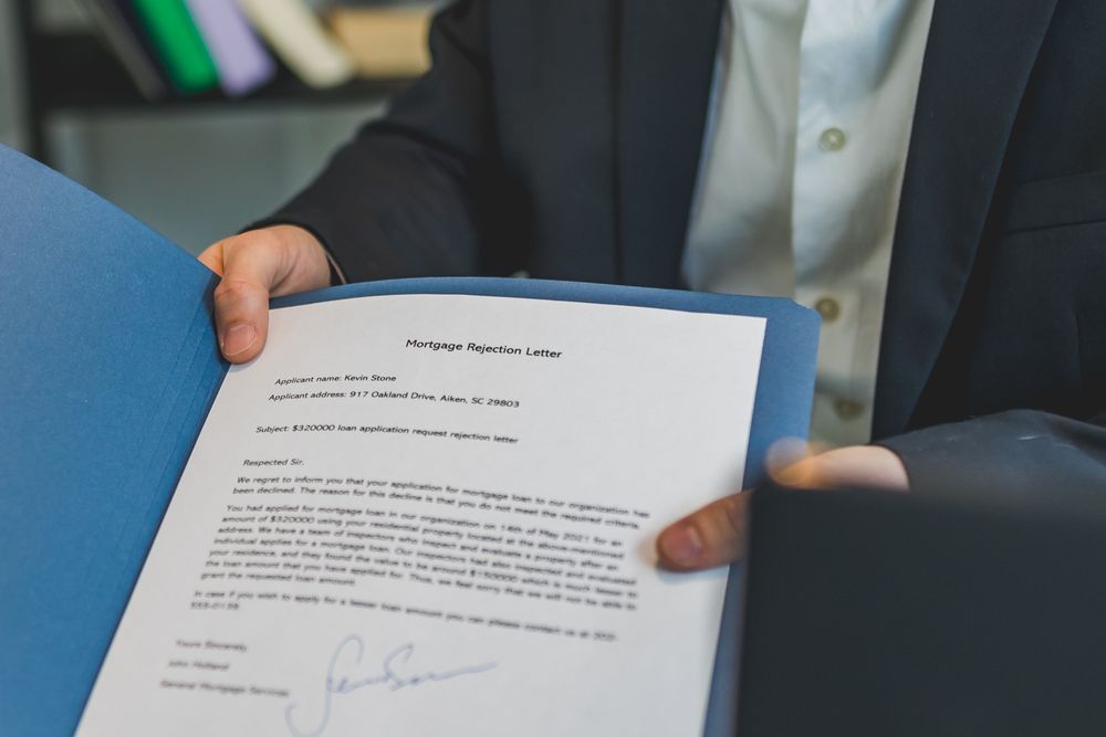 Loan paperwork being reviewed with an adviser, comparing debt consolidation with the debts it replaces