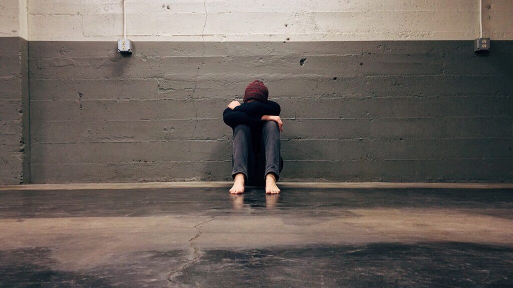 Person with head in hands worried about debt