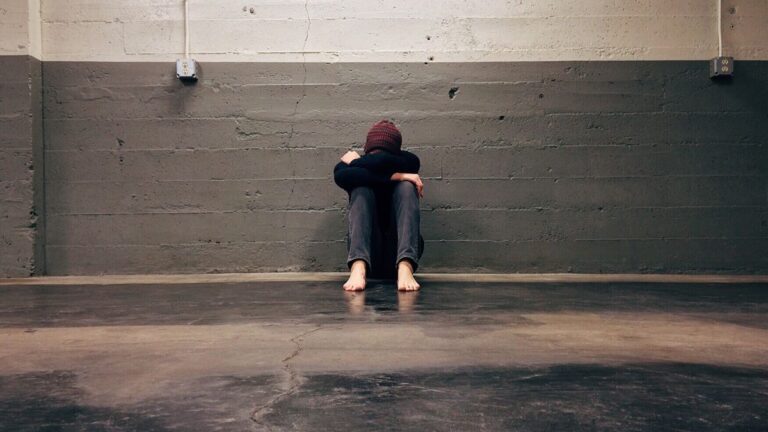 Person with head in hands worried about debt