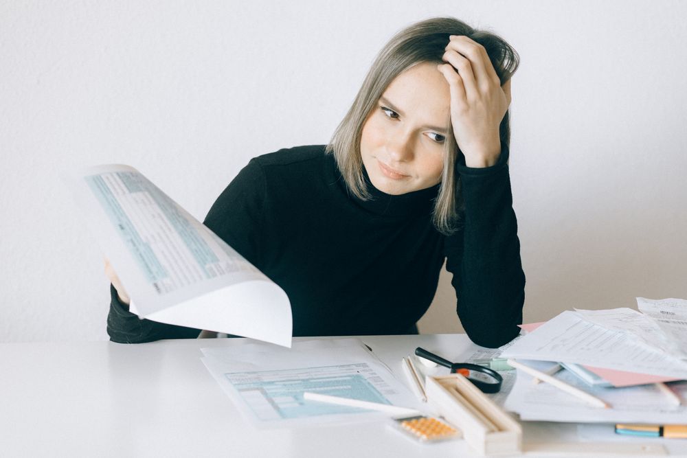 Person going through bills and receipts at a table