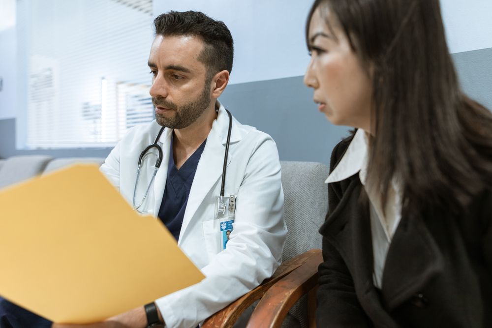 Doctor consulting with a patient, one of the real emergencies that emergency loans are used for