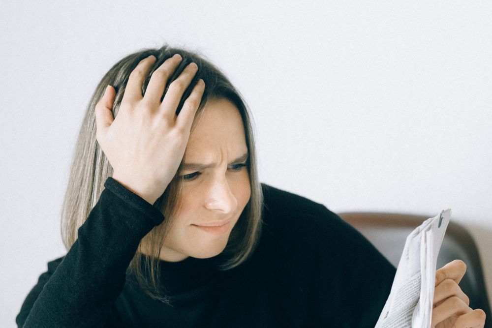 Person going through bills and receipts at a table