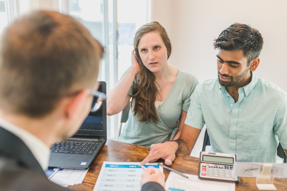 People meeting an adviser to talk about money, a yearly financial check-up