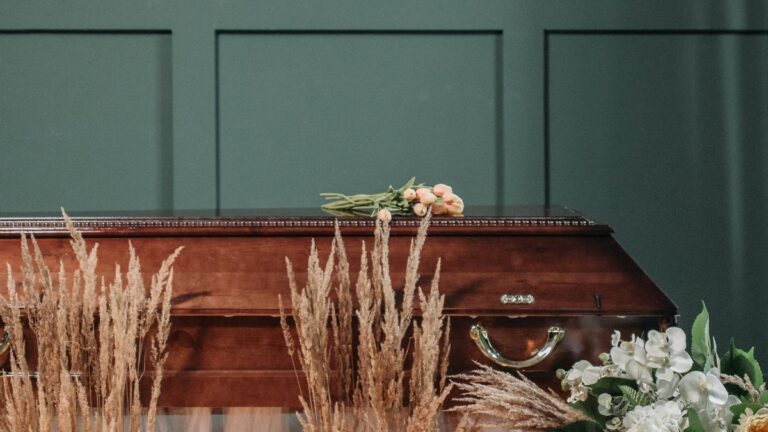 Flowers and a casket at a funeral