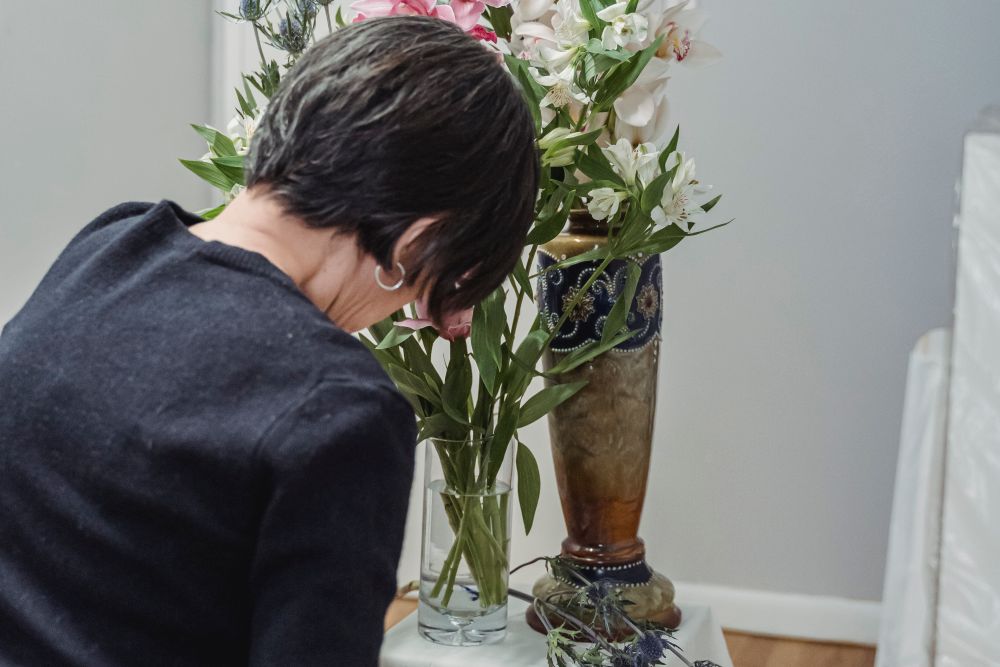 Flowers and a casket at a funeral, the costs funeral cover is meant to pay