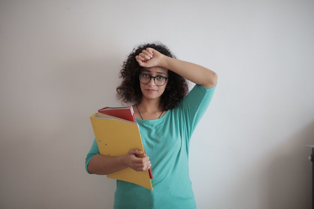 Person worried while going through bills at home, worrying about a garnishee order on your payslip