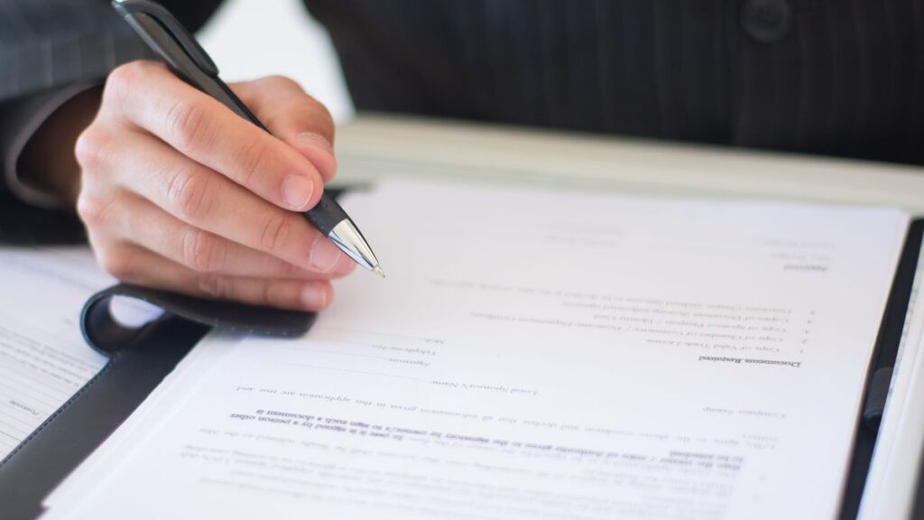 Person reading a loan agreement with fixed monthly instalments