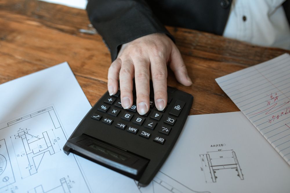 Calculator and household bills laid out on a table, used to compare installment loans for bad credit