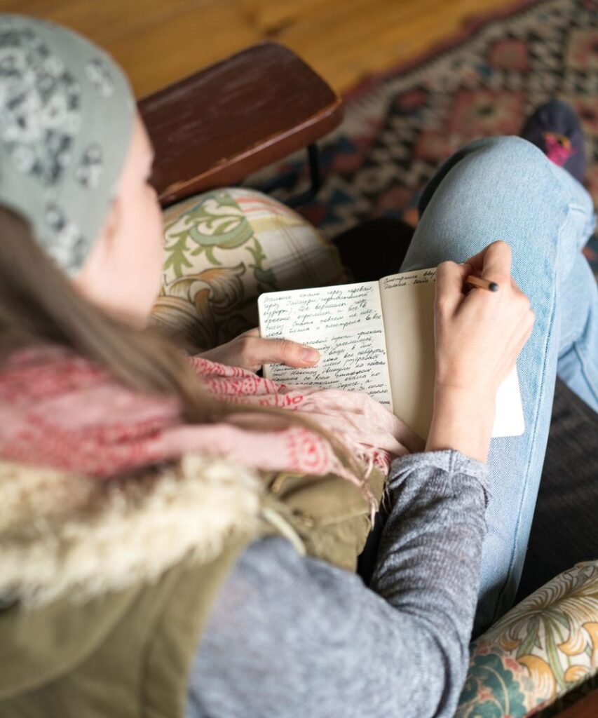 Person writing notes in a notebook