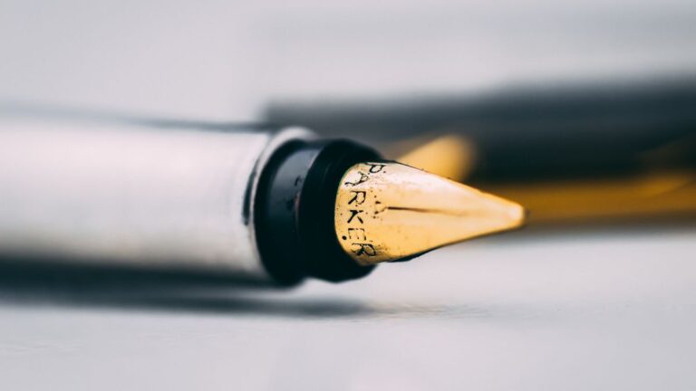 Person writing a will with a pen on paper