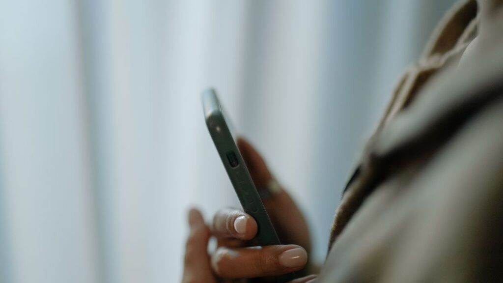 Hands holding a smartphone, representing instant loan apps