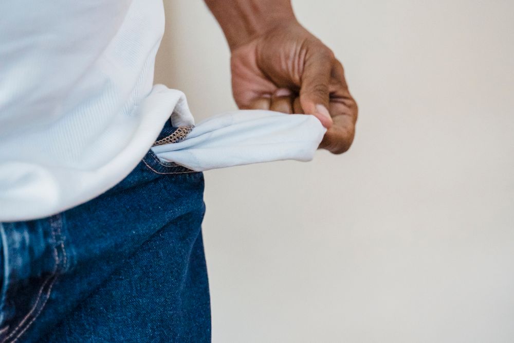 Empty wallet and pockets showing no money left, the moment instant cash loans feel tempting