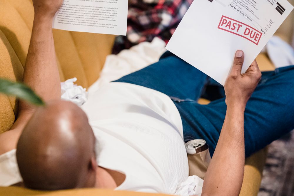 Person stressed over overdue bills, the worry after a court judgment about judgment debt
