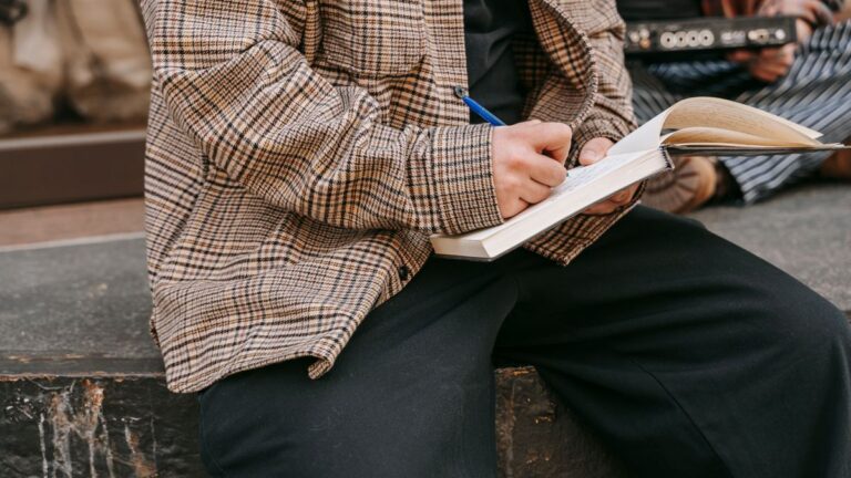 Person writing notes while reading loan terms