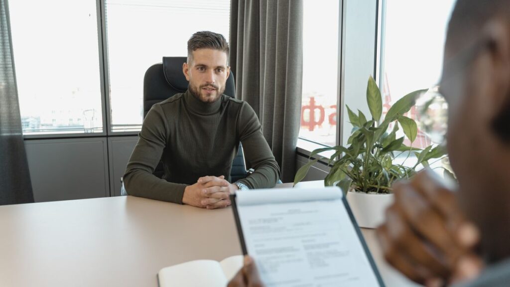 Person searching for work with a CV and job notices