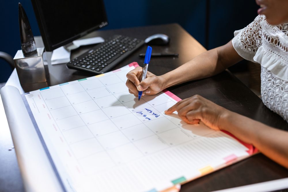 Notebook, calculator and papers on a desk during monthly budget planning
