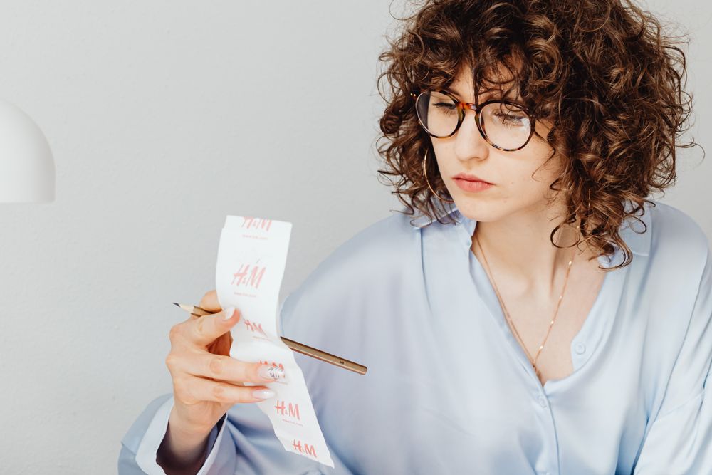 Person going through bills and receipts at a table