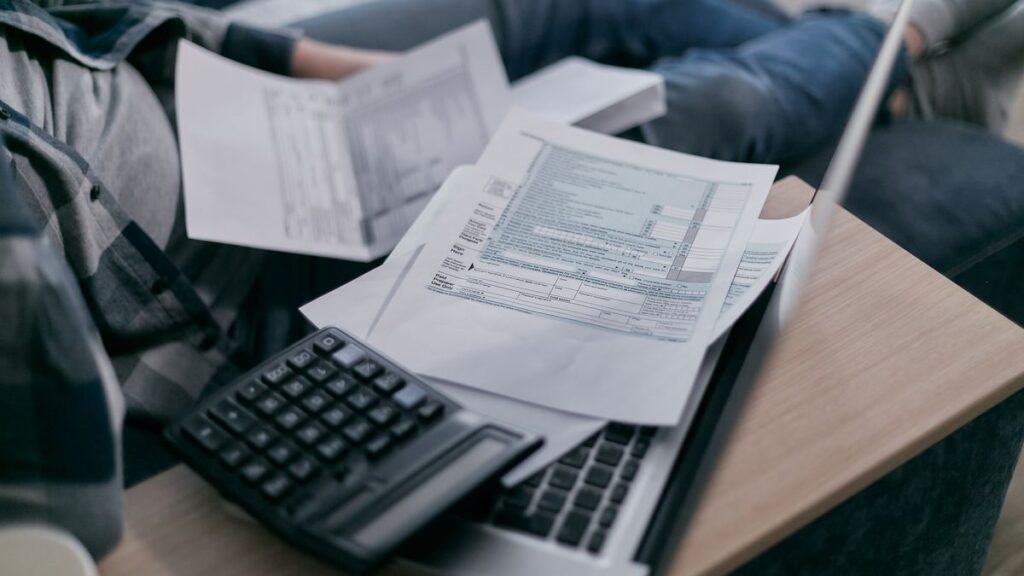 Person going through bills and receipts at a table