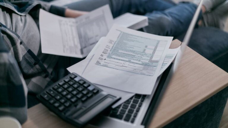 Person going through bills and receipts at a table