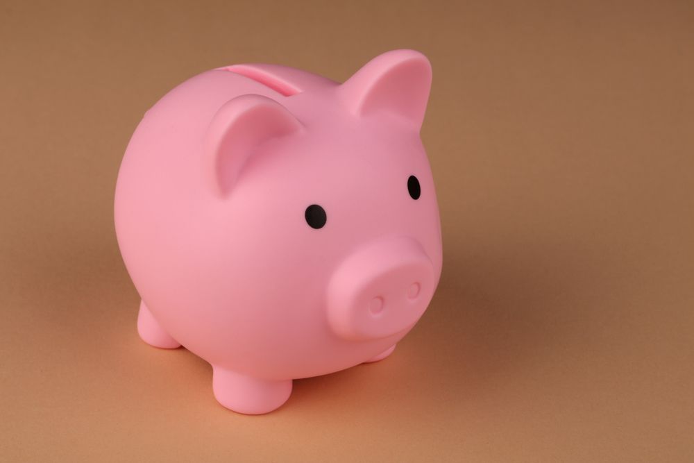 Savings jar with coins, a small amount that mini loans can make surprisingly expensive