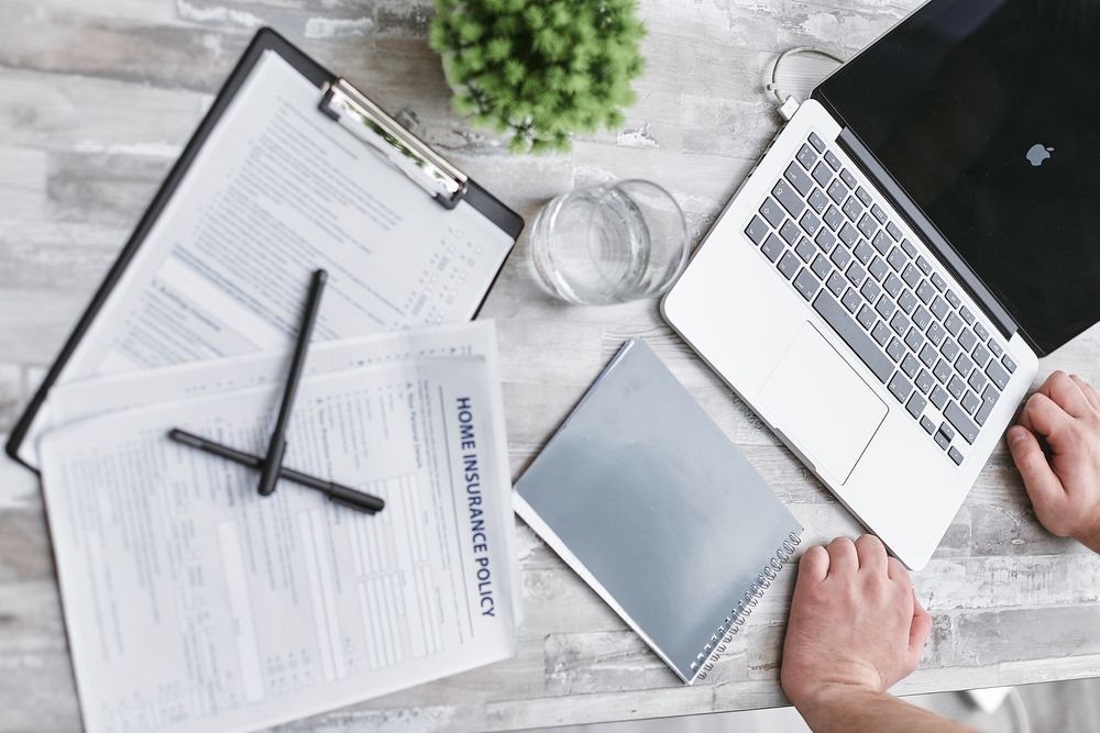 Loan paperwork being reviewed with an adviser, writing money resolutions with a number and a date