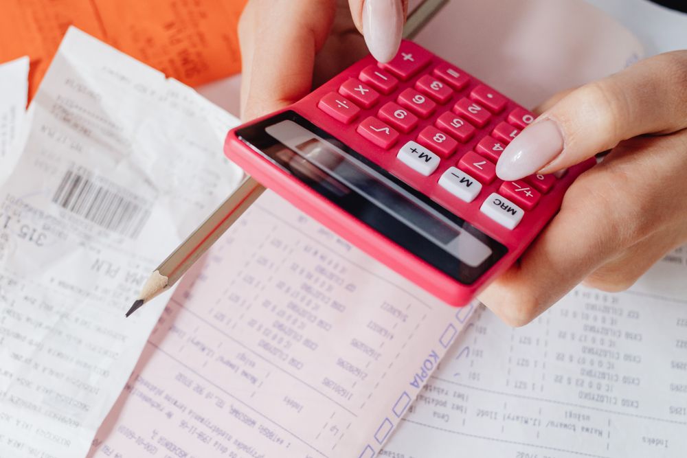 Notebook ledger and phone for tracking a monthly budget