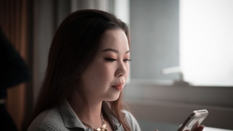 Person completing an online loan application on a smartphone