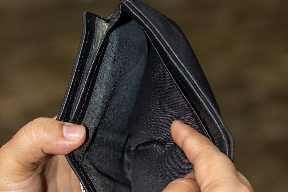 Empty wallet and hands, living paycheck to paycheck