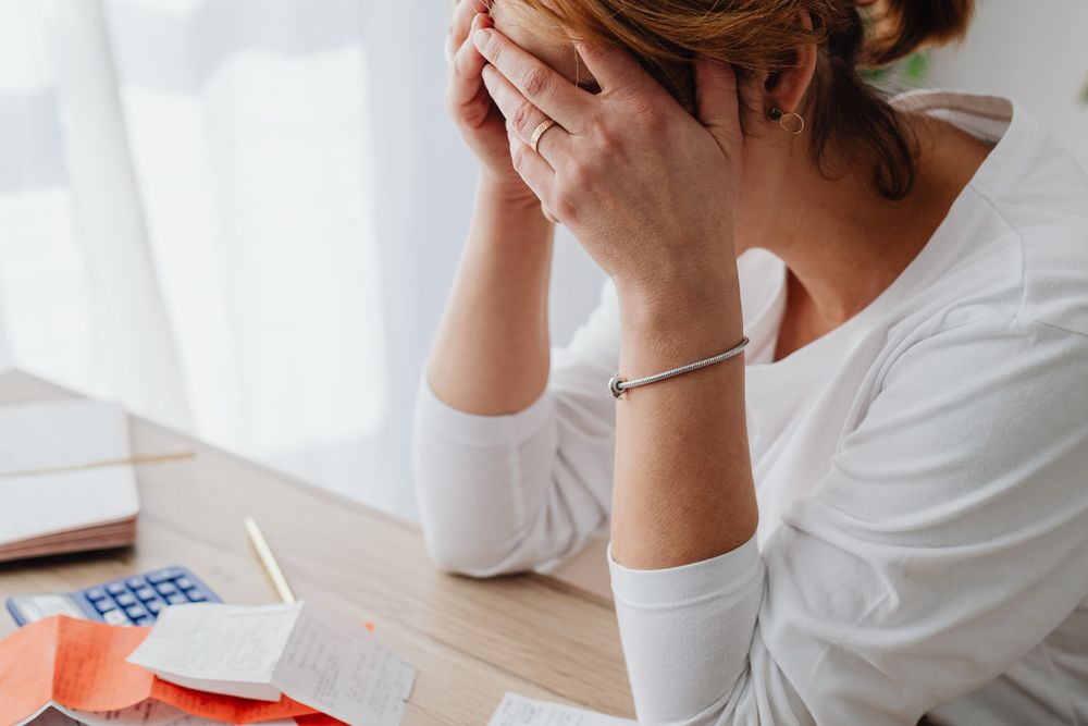 Person going through bills and receipts at a table