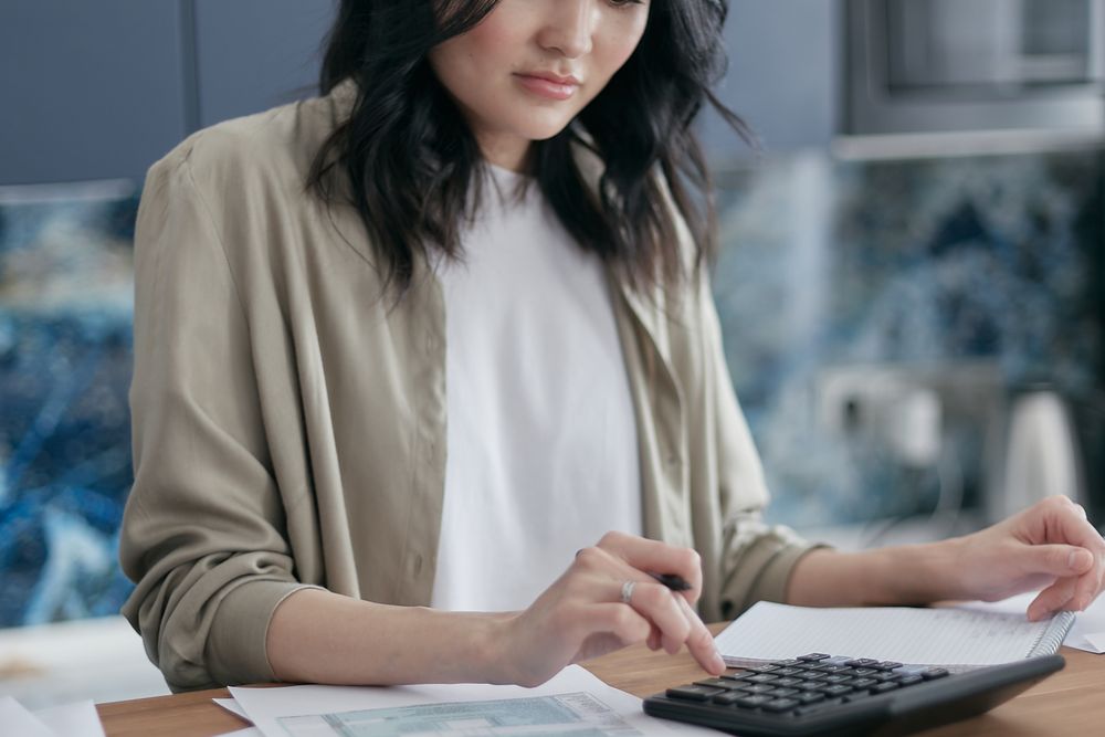 Couple going through household finances at a table, planning how to repay payday loans with bad credit