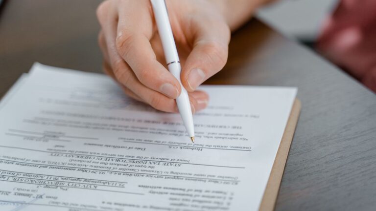 Tax and payslip documents on a desk with a calculator