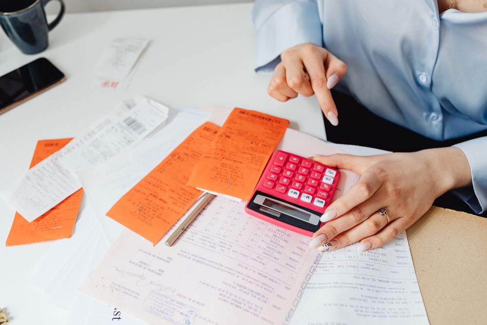 Invoices and paperwork being reviewed, checking a payslip line by line