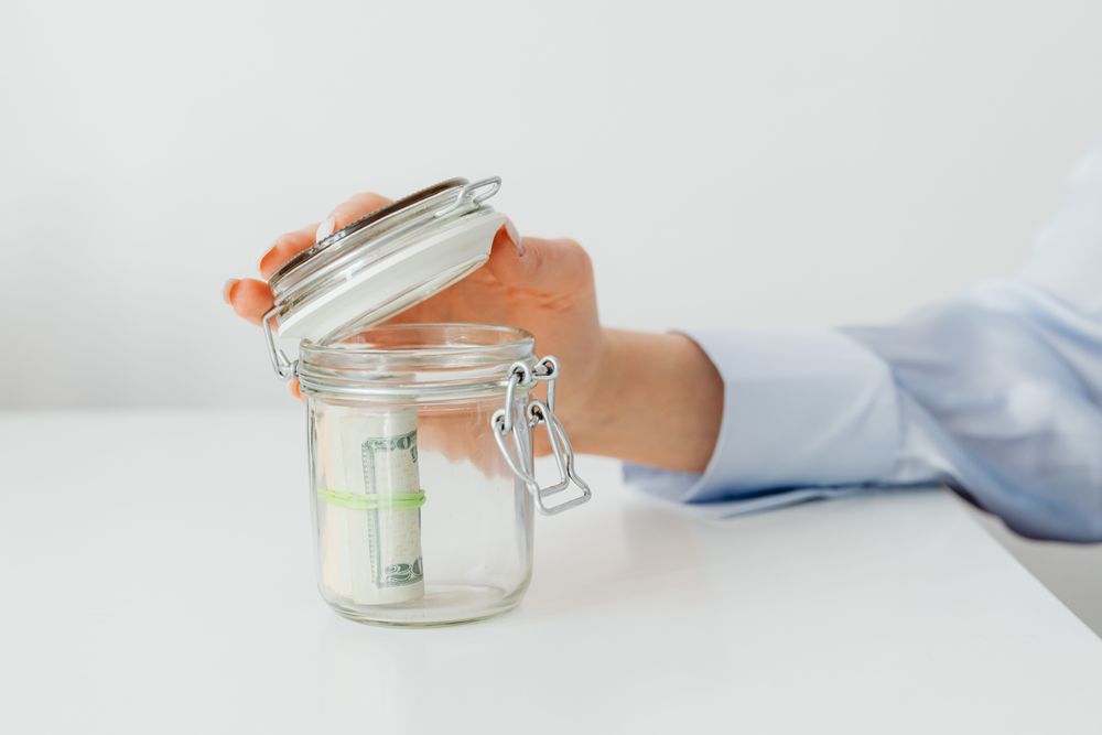 Savings jar and a savings tracker, the cheaper way to fund a trip than a personal loan for vacation