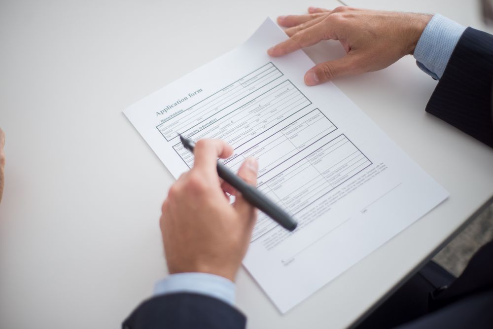 Job search with a CV and employment papers, proof of income that helps you qualify for a no credit check loan
