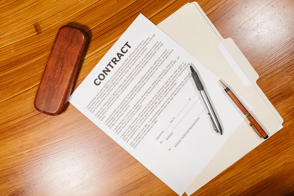 Person reading and signing a credit agreement after checking the requirements for a no credit check loan