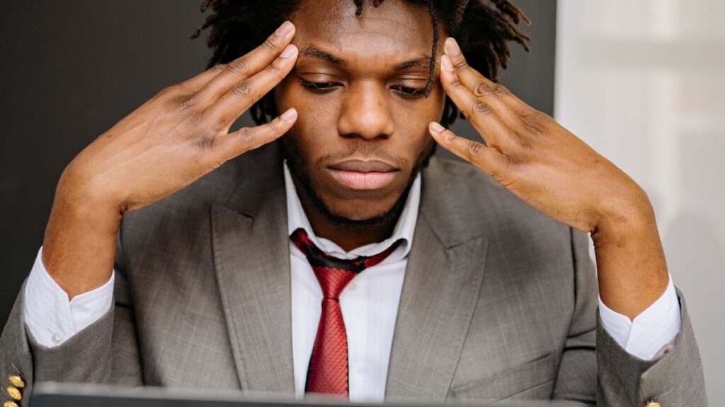 Worried person checking loan options on a phone and papers at home